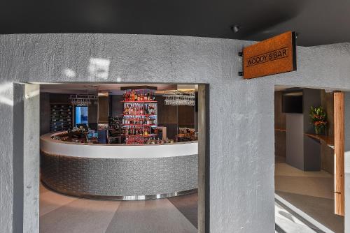 a restaurant with a counter with bottles of wine at Peppers Silo Launceston in Launceston