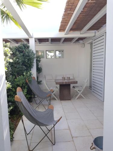 a patio with chairs and a table on a patio at Casa Mirella in Favignana
