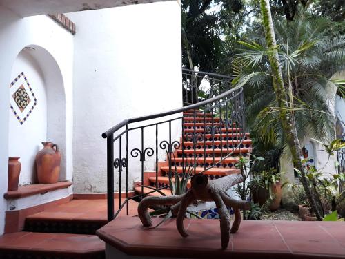 a statue of an insect sitting on a staircase at Casa Constantino in Rivera