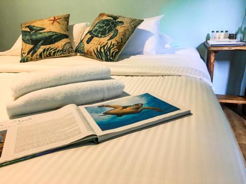 a bed that has a book on it at Safari Lodge in Cape Tribulation