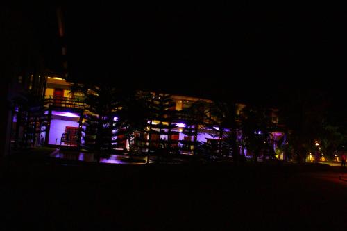 a building at night with purple lights on it at Hotel Green Garden in Trincomalee