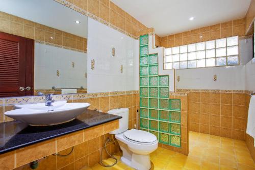 a bathroom with a sink and a toilet at Tropical Family Retreat near Ya Nui Beach - Villa Nikkie in Nai Harn Beach
