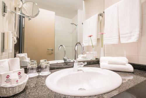 a bathroom with a white sink and a mirror at Best Western Plus Hotel Am Schlossberg in Nürtingen