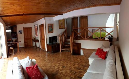 a living room with a couch and a staircase at Villa ChezSoa, Antananarivo in Antananarivo