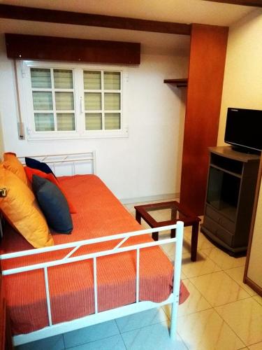 a bedroom with a bed and a window at Mar de Rosas in O Grove