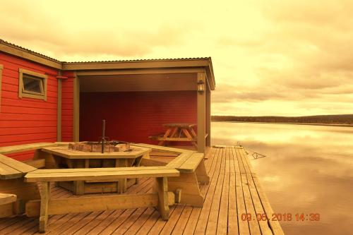 a wooden deck with a sink on the water at Camp Alta Kiruna in Kiruna
