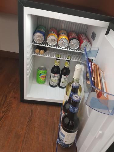 
a refrigerator filled with bottles and bottles of alcohol at Hotel Amber Altstadt in Stralsund

