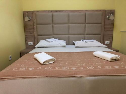 a bedroom with a large bed with two towels on it at Altstadt von Budva in Budva
