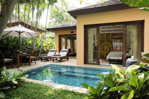a pool in the backyard of a villa at Mövenpick Asara Resort & Spa Hua Hin in Hua Hin
