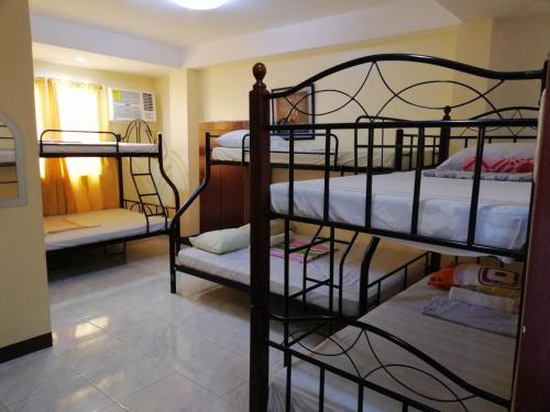 a room with four bunk beds in a room at Haus Of Tubo Davao in Davao City