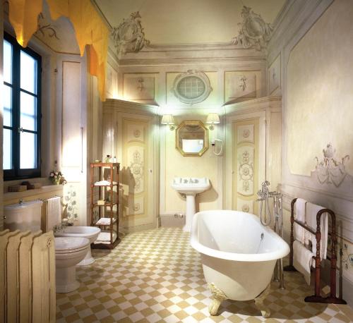 a bathroom with a tub and a sink and a toilet at Villa Il Poggiale Dimora Storica in San Casciano in Val di Pesa