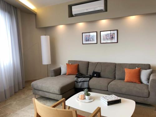 a living room with a couch and a table at Grey Apartment Lebanon by Grey pearls in Jounieh