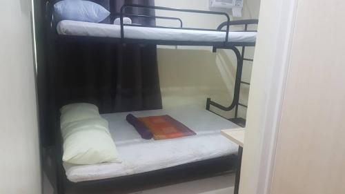 a couple of bunk beds in a room at Haus Of Tubo Davao in Davao City