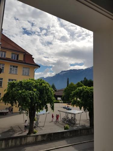 a view of a courtyard with a table and trees at Interlaken Apartments in Interlaken