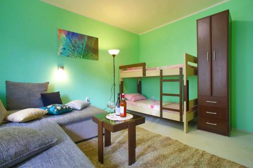 a living room with a couch and bunk beds at Aparthotel Monterria in Bar