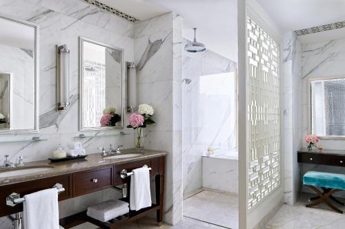 a bathroom with a sink and a tub at The Langham, Shenzhen in Shenzhen