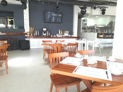 a dining room with wooden tables and chairs at Dionisos Hotel in Malia