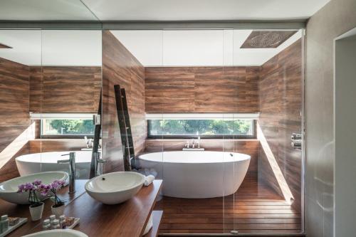 a bathroom with two sinks and a large tub at Quinta do Fontelo in Vouzela