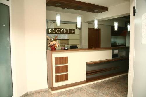 a lobby of a hotel with a reception counter at Euro House Hotel in Baia Mare