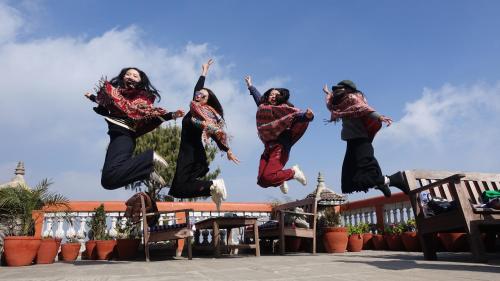 a group of women jumping in the air at Peaceful Cottage & Cafe Du Mont in Nagarkot