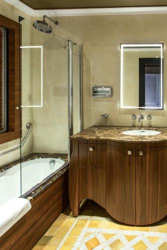 a bathroom with a tub and a sink and a shower at Château Roslane Boutique hôtel & Spa in Meknès