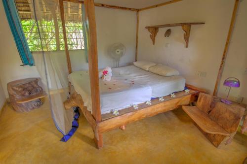 a bedroom with a bed in a room at Distant Relatives Ecolodge & Backpackers in Kilifi