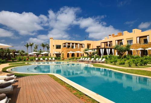 a swimming pool in front of a resort at Château Roslane Boutique hôtel & Spa in Meknès