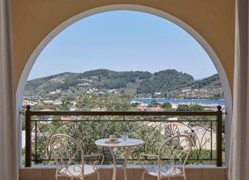 a dining room with a balcony overlooking the ocean at Skiathos Living in Skiathos