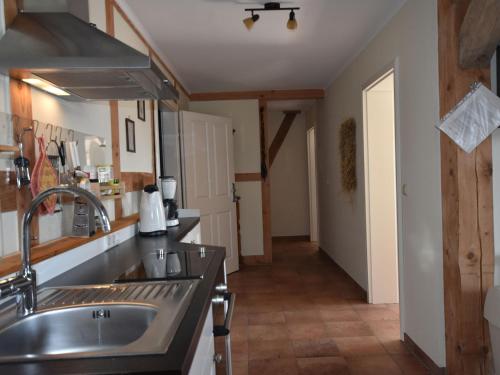 a kitchen with a sink and a stove at Ferienwohnung Im Heumond in Buschhagen in Buschenhagen