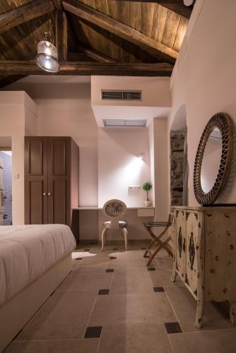 a bedroom with a bed and a desk and a chair at Mythic Valley in Litochoro