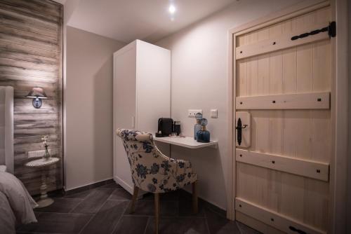 a bedroom with a bed and a chair and a desk at Mythic Valley in Litochoro
