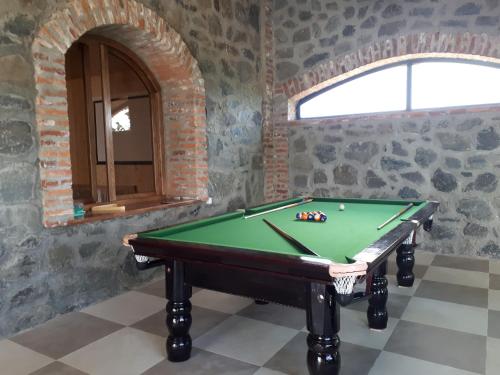 a room with a pool table and a window at Shaloshvili's Cellar Hotel in Shilda