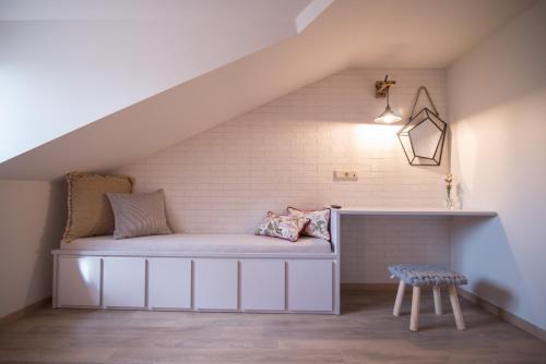a room with a bench under the stairs at Mythic Valley in Litochoro