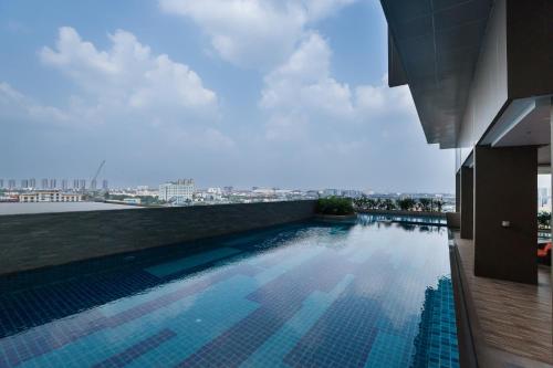 a swimming pool on the roof of a building at Best Western Plus Wanda Grand Hotel in Nonthaburi