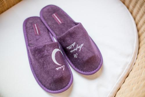 a pair of purple flip flops on a table at Agriturismo Il Sapore Della Luna in Monteprandone