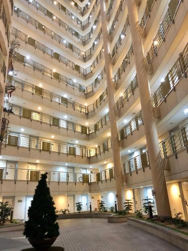 a large building with a christmas tree in the courtyard at Incheon Airport Guesthouse in Incheon