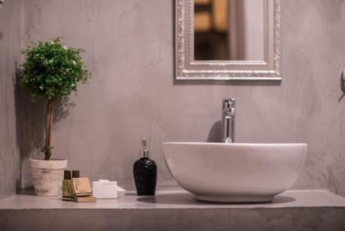 a bathroom with a white sink and a mirror at Mythic Valley in Litochoro