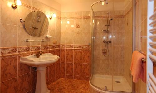 a bathroom with a sink and a shower at Spa Hotel Purkyně in Karlovy Vary