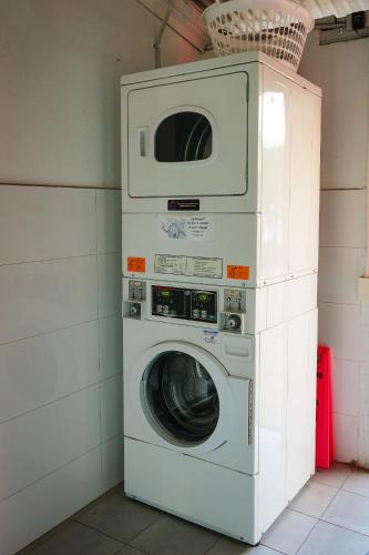 a washer and dryer stacked on top of each other at Haus Accommodation - note - Valid passport required to check-in in Perth