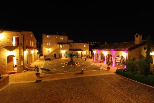 a group of buildings with lights on them at night at Agriturismo Il Sapore Della Luna in Monteprandone