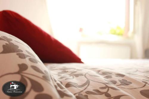a bed with a pillow with a sticker on it at Nonna Francesca in Patti