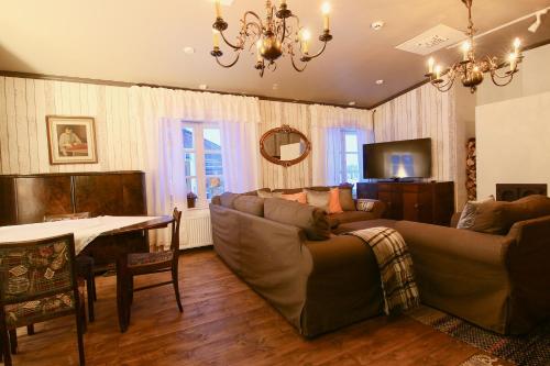 a living room with a couch and a table at Elves Village Hotel in Levi