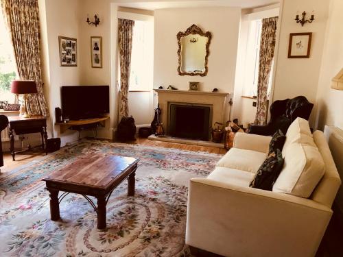 a living room filled with furniture and a fire place at Tresillian House in Melton Mowbray