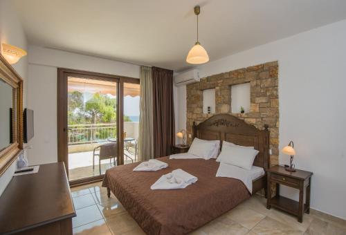 Postel nebo postele na pokoji v ubytování Marilena Apartments