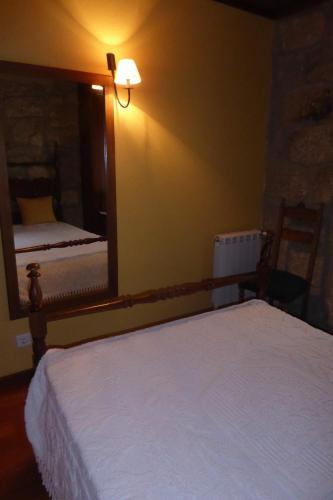 a bedroom with two beds and a large mirror at Casa do Rio in Moita