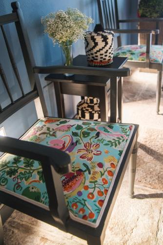 a chair with a flowered seat sitting next to a table at Hotel Edouard VII in Biarritz