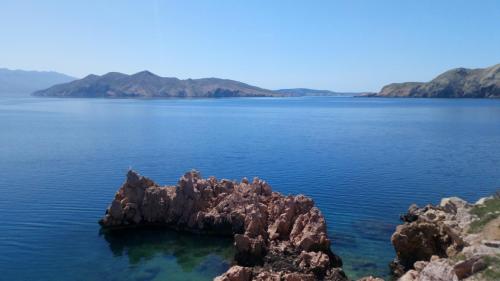a large body of water with mountains in the background at Lavender in Baška