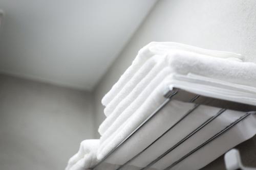 a pile of towels on a towel rack in a room at Dönhoff Residence in Pärnu