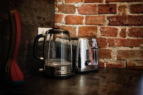 a blender sitting on a counter next to a brick wall at Dönhoff Residence in Pärnu