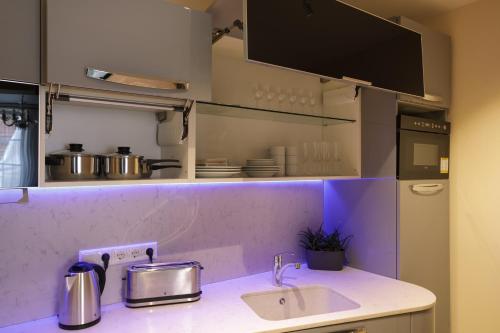 a kitchen with a sink and a counter top at Dönhoff Residence in Pärnu